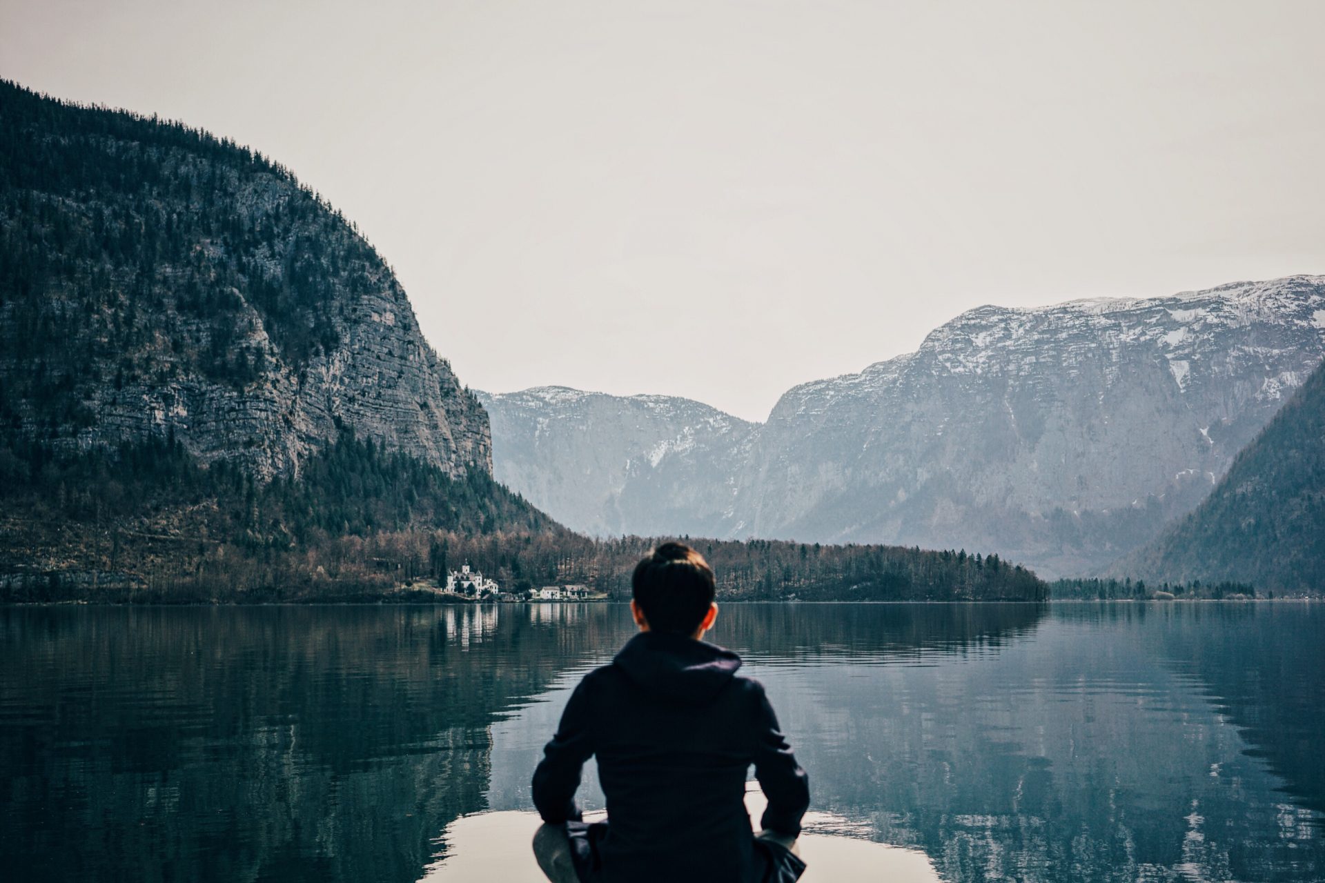 person meditating on a dock